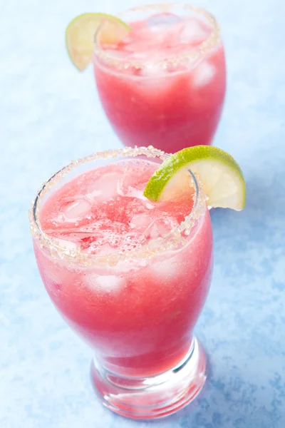 Two glasses of watermelon cocktail with brown sugar and lime