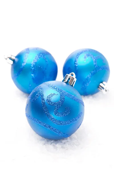 Three blue Christmas balls on snow isolated — Stock Photo, Image