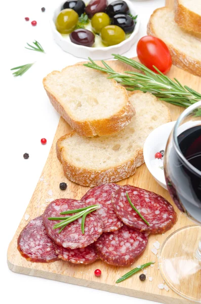 Antipasto - salami, bread, olives and glass of wine isolated — Stock Photo, Image