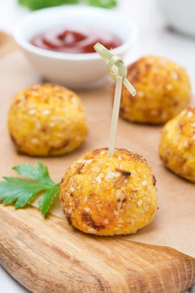 Chicken meatballs in corn breading with tomato sauce on board — Stock Photo, Image