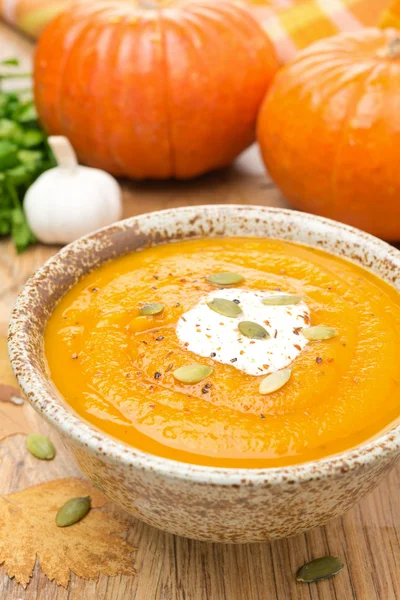 Pumpkin soup with coriander and cream in a bowl, vertical — Stock Photo, Image
