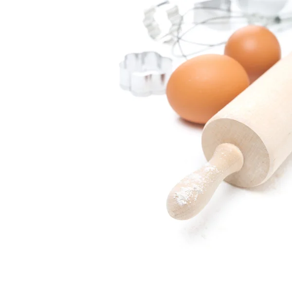 Rolling pin, eggs and cookie cutters, selective focus, isolated — Stock Photo, Image