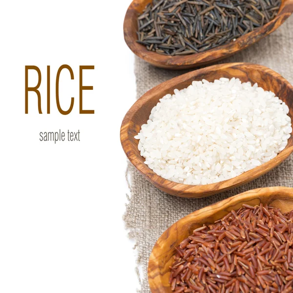 Varieties of rice in wooden bowls, selective focus, isolated — Stock Photo, Image