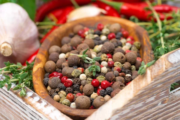 Wooden bowl with assorted dried peppers and spices — Stock Photo, Image
