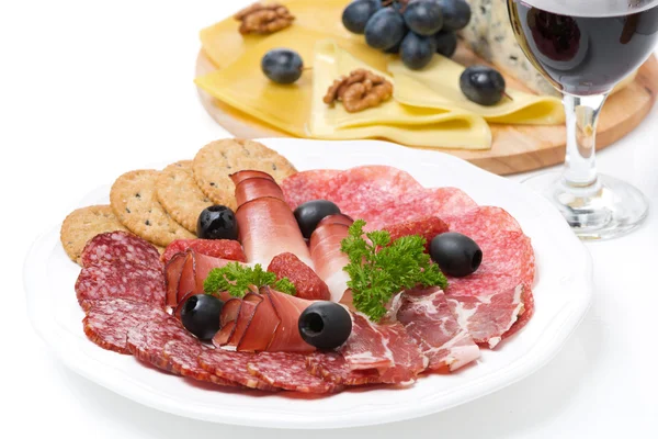 Assorted deli meats, plate of cheese and glass of wine closeup — Stock Photo, Image