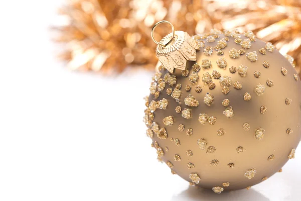 Golden Christmas ball and tinsel, isolated — Zdjęcie stockowe