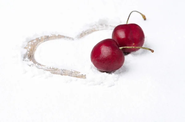 Heart painted on the backdrop of powdered sugar and two cherries — Stock Photo, Image