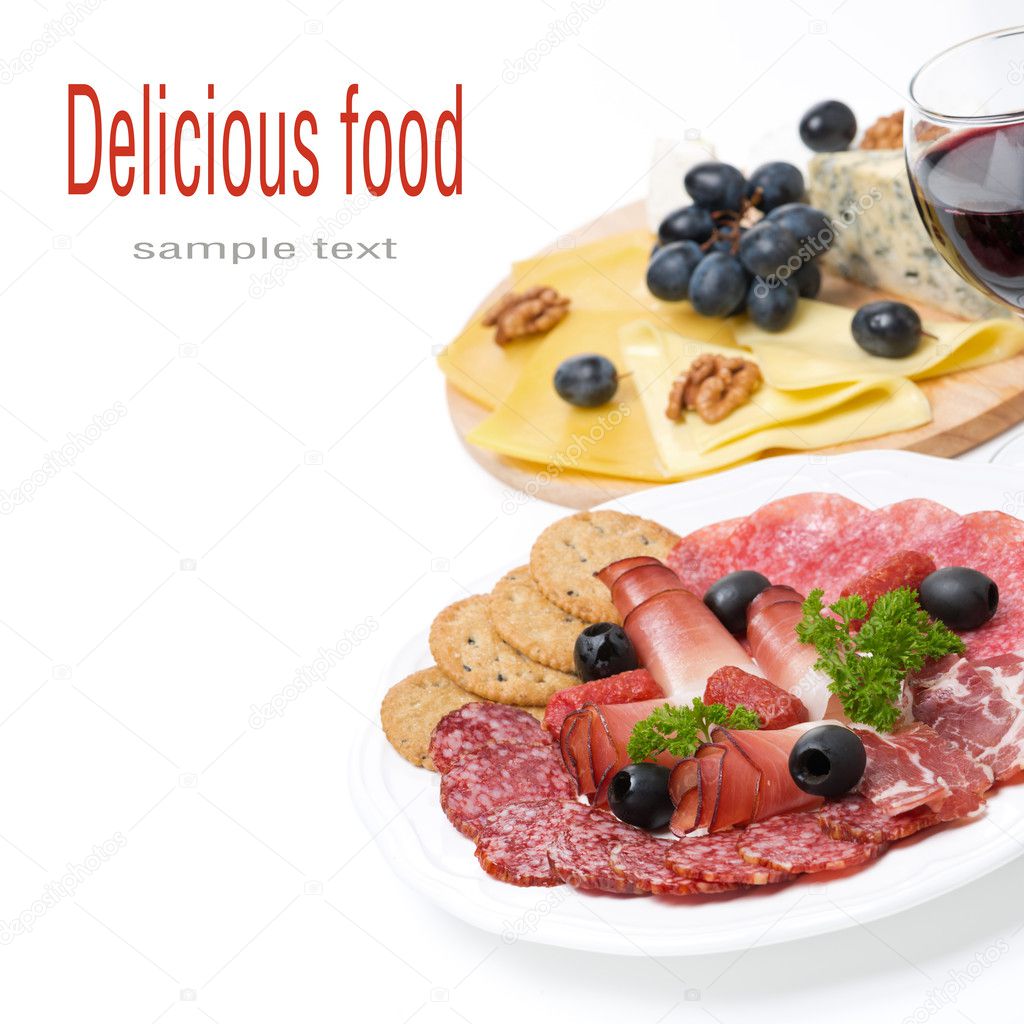 Assorted deli meats, plate of cheese and a glass of wine — Stock Photo