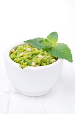 yakın çekim yeşil bezelye pesto ile beyaz zemin üzerine nane