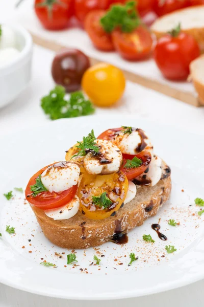 Piece of ciabatta with mozzarella and colorful cherry tomatoes — Stock Photo, Image