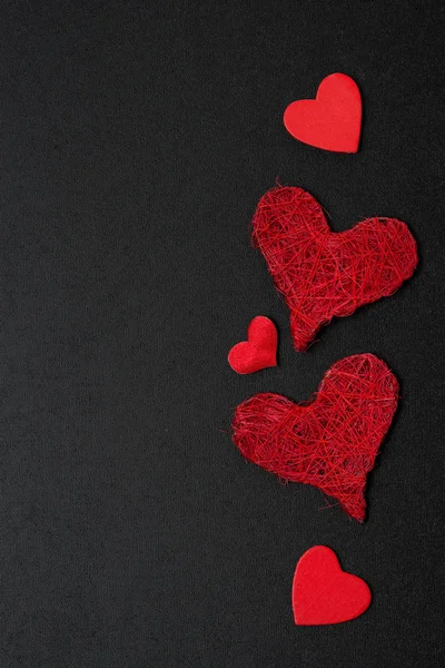 Black background with different red hearts — Stock Photo, Image