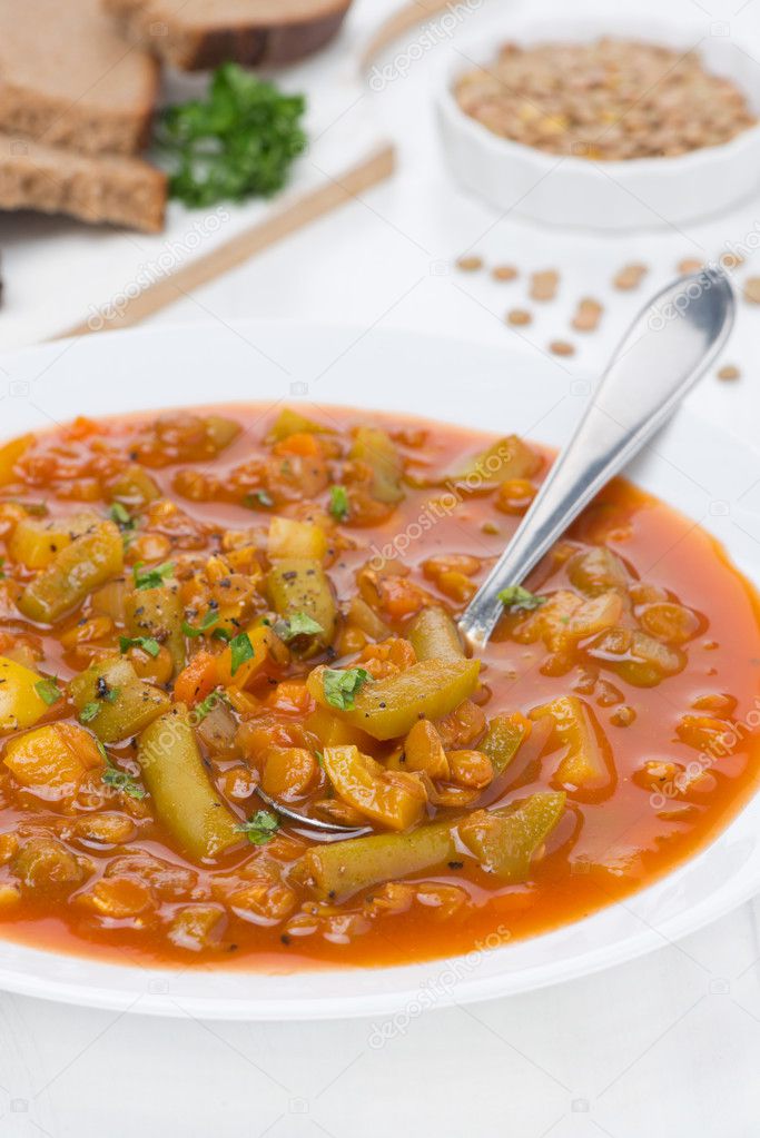 Spicy tomato soup with green lentils and vegetables, vertical