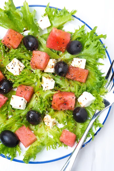 Salad with watermelon, feta cheese and olives on the plate — Stock Photo, Image