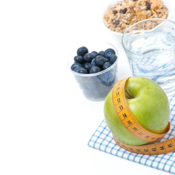 Healthy food concept - apple, blueberry, water and muesli — Stock Photo, Image