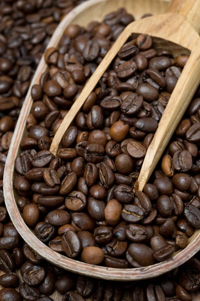 Tigela de madeira e colher com grãos de café, vertical — Fotografia de Stock