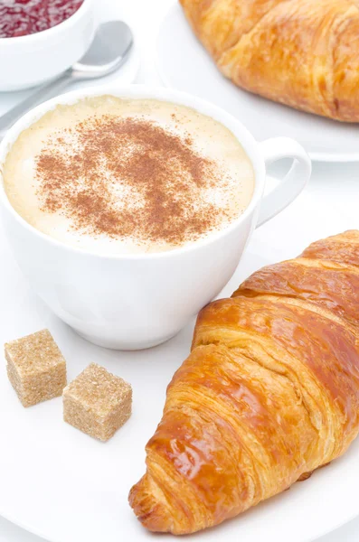 Fresh croissant, cappuccino and jam for breakfast, close-up — Stock Photo, Image