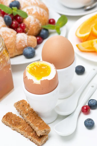Śniadanie z jaja, tosty, rogaliki, świeże owoce — Zdjęcie stockowe
