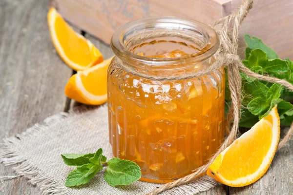 orange marmalade in a glass jar, close-up