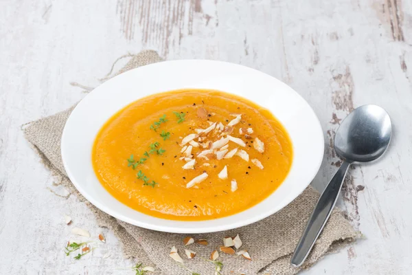 Plate of carrot soup with almonds and watercress — Stock Photo, Image