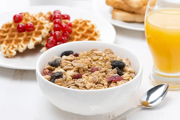 Muesli, waffles with berries and orange juice for breakfast — Stock Photo, Image