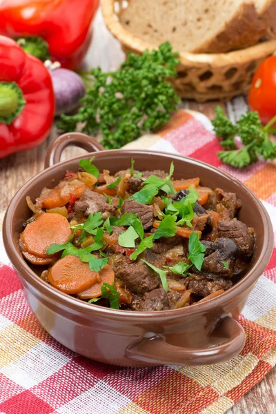 Stew with beef, vegetables and prunes in a saucepan, vertical — Stock Photo, Image