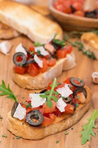 Ciabatta with tomatoes, olives, parmesan cheese and herbs — Stock Photo, Image