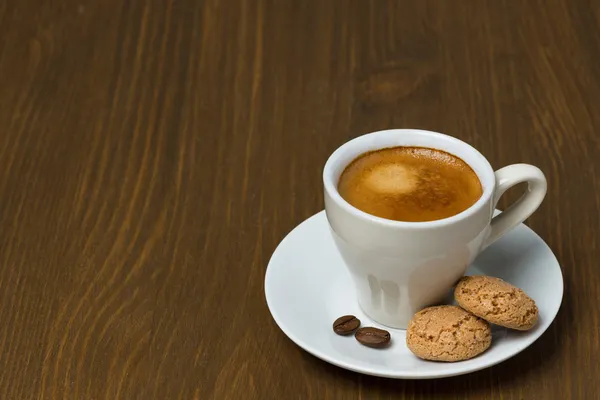 Cup of coffee and biscotti on a wooden table and space for text — Stock Photo, Image