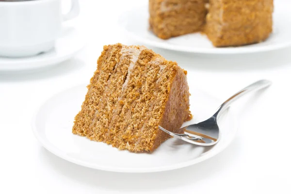 Piece of honey cake  and fork on a white plate — Stock Photo, Image