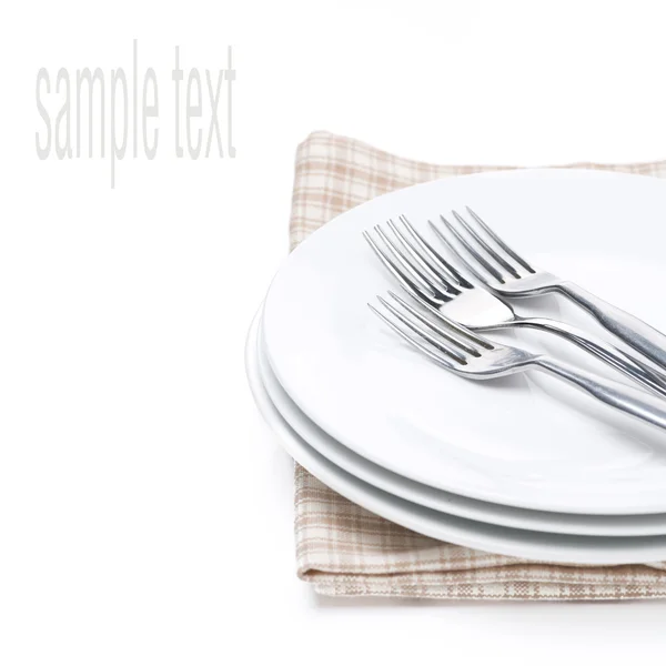 Plates and forks - utensils for serving on napkin, isolated — Stock Photo, Image