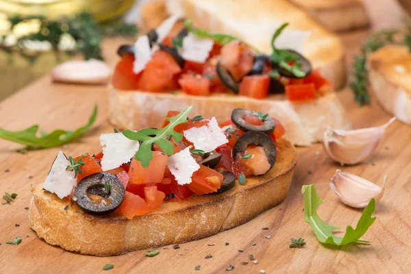 Ciabatta with tomatoes, olives, parmesan cheese and herbs — Stock Photo, Image