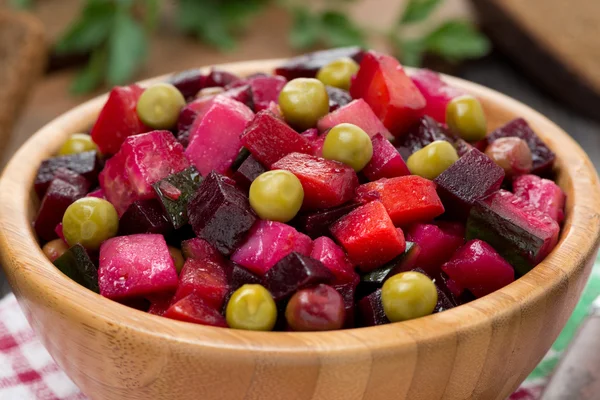 Russian beetroot salad vinaigrette in a wooden bowl, close-up — Stock Photo, Image