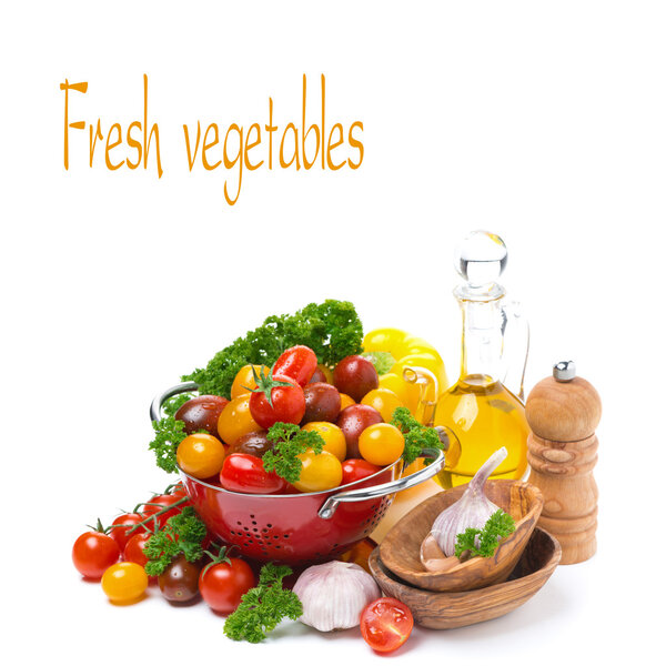 Cherry tomatoes in a colander, olive oil and fresh herbs