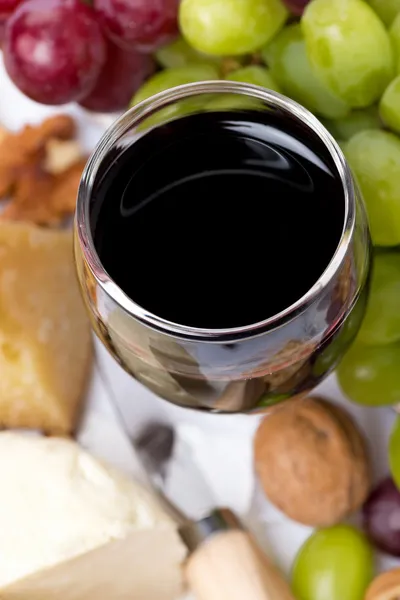 Glas Rotwein aus nächster Nähe, Käse und Trauben, Draufsicht — Stockfoto