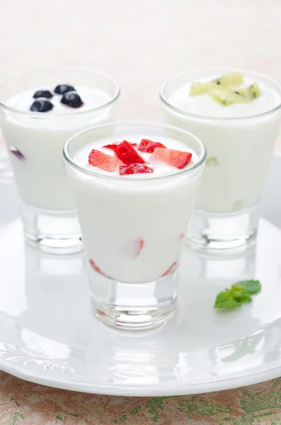 Three yogurt with fruit in a glass beaker — Stock Photo, Image