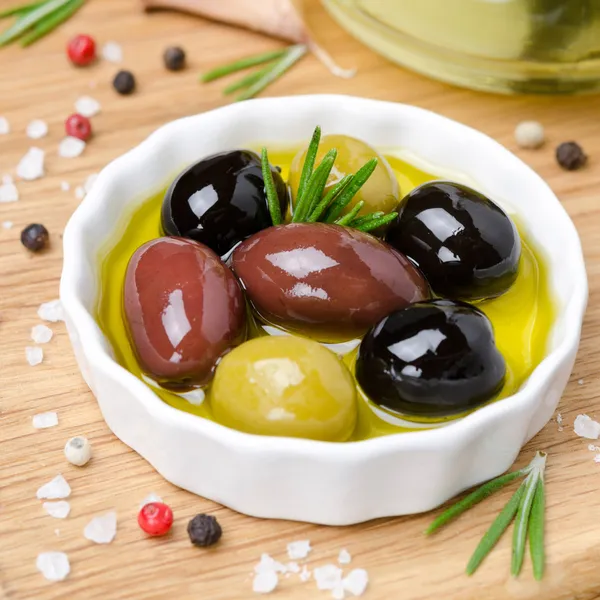 Assorted olives in olive oil, top view — Stock Photo, Image