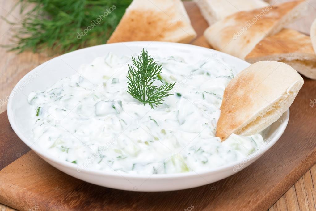 yoghurt sauce tzatziki with herbs, cucumber and garlic and pita 
