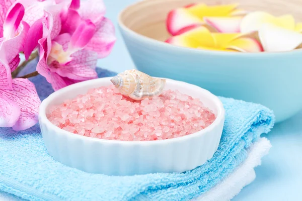 Spa setting with with sea salt and pink flowers