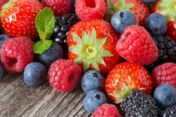 Assorted fresh berries on wooden background, close-up — Stock Photo, Image