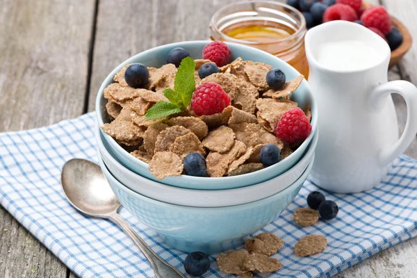 cereal with berries, honey and milk, closeup