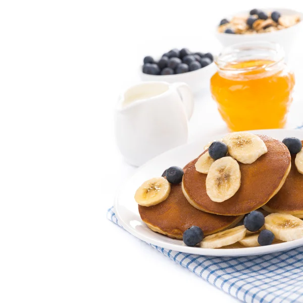 Pancakes with banana and blueberries, yogurt, muesli, isolated — Stock Photo, Image