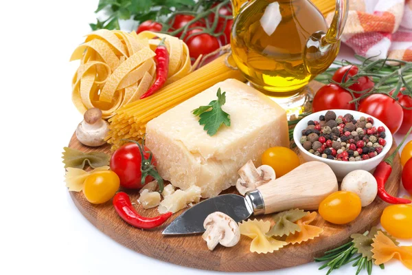 Parmesan, spices, tomatoes, olive oil, pasta and herbs on board — Stock Photo, Image