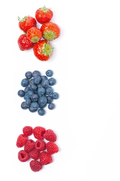Raspberries, blueberries and strawberries, top view, isolated — Stock Photo, Image