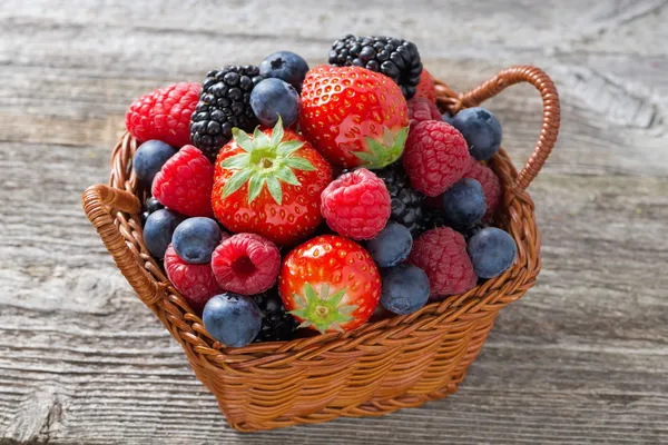 Basket with fresh seasonal berries, top view — Stock Photo, Image