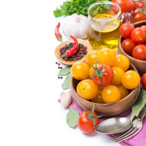 Gele en rode kerstomaten in kom, olijfolie en specerijen — Stockfoto