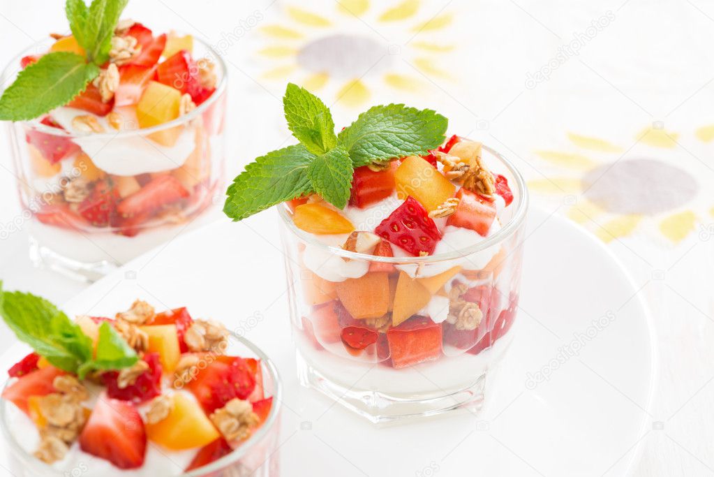 Dessert with strawberries, apricots, whipped cream and mint