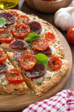 Salam ve ahşap tahta üzerinde domates lezzetli pizza