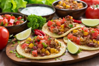 Mexican cuisine - tortillas with chili con carne, tomato salsa clipart