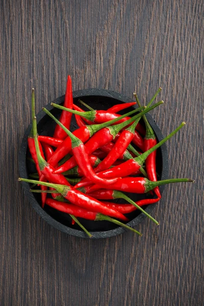 Ciotola con peperoncino fresco su fondo di legno, vista dall'alto — Foto Stock