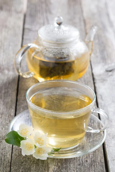 Kettle and a cup of green tea with jasmine — Stock Photo, Image