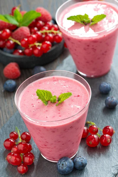 Refreshing milkshake with fresh berries and mint in glass — Stock Photo, Image